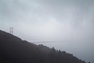 Golden Gate Bridge, behind curtain of fog.